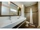 Modern bathroom with double sinks, a large mirror, and a walk-in shower at 1561 Corolla Ct, Reunion, FL 34747