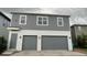 Two-story house with gray siding, two-car garage, and a light gray door at 14663 Englert Aly, Orlando, FL 32827