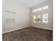 Bright bedroom with neutral walls, carpet, and multiple windows at 14663 Englert Aly, Orlando, FL 32827
