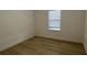 Bright bedroom with wood-look flooring and window blinds at 14663 Englert Aly, Orlando, FL 32827