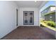Covered patio with brick pavers and double french doors at 14663 Englert Aly, Orlando, FL 32827