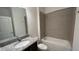 Bathroom with granite countertop, tub, and tiled shower at 14663 Englert Aly, Orlando, FL 32827