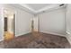 Spacious bedroom with carpet, door to bathroom, and window with blinds at 14663 Englert Aly, Orlando, FL 32827