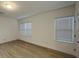 Spacious bedroom with light walls, wood-look floors, and window blinds at 14663 Englert Aly, Orlando, FL 32827
