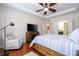 Bright bedroom featuring a comfortable sitting area and large TV at 6316 Miramonte Dr # 106, Orlando, FL 32835