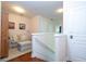 Upstairs hallway with seating area and hardwood floors at 6316 Miramonte Dr # 106, Orlando, FL 32835