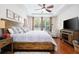 King size bed, large windows and hardwood floors at 6316 Miramonte Dr # 106, Orlando, FL 32835