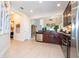 Modern kitchen featuring dark wood cabinets, stainless steel appliances, and tile flooring at 6316 Miramonte Dr # 106, Orlando, FL 32835