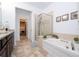 Elegant bathroom with double vanity and soaking tub at 6316 Miramonte Dr # 106, Orlando, FL 32835