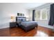 Bedroom with gray bedding, hardwood floors, and window at 6316 Miramonte Dr # 106, Orlando, FL 32835