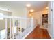 Upper hallway with hardwood floors and white railings at 6316 Miramonte Dr # 106, Orlando, FL 32835