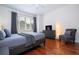 Bedroom with gray bedding, hardwood floors, and armchair at 6316 Miramonte Dr # 106, Orlando, FL 32835