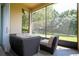 Relaxing screened porch with wicker furniture and view of backyard at 6316 Miramonte Dr # 106, Orlando, FL 32835