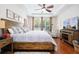 King size bed, large windows and hardwood floors at 6316 Miramonte Dr # 106, Orlando, FL 32835