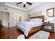 Spacious bedroom with hardwood floors and a large bed at 6316 Miramonte Dr # 106, Orlando, FL 32835