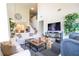 Spacious living room with high ceilings, comfortable seating, and large TV at 6316 Miramonte Dr # 106, Orlando, FL 32835