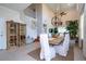 Spacious dining area with a wooden table, white chairs, and a view of the staircase at 6316 Miramonte Dr # 106, Orlando, FL 32835