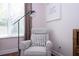 Cozy sitting area with comfortable chair and floor lamp at 6316 Miramonte Dr # 106, Orlando, FL 32835