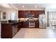 Modern kitchen with stainless steel appliances and dark wood cabinets at 6316 Miramonte Dr # 106, Orlando, FL 32835