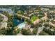 Aerial view of community with pool, lake, and tennis courts at 6316 Miramonte Dr # 106, Orlando, FL 32835