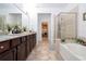 Elegant bathroom with double vanity and soaking tub at 6316 Miramonte Dr # 106, Orlando, FL 32835