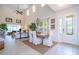 Bright dining room features a large wooden table with white chairs and a high ceiling at 6316 Miramonte Dr # 106, Orlando, FL 32835
