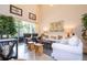 Relaxing living room with high ceilings, white sofa and armchairs, and natural light at 6316 Miramonte Dr # 106, Orlando, FL 32835