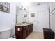 Bathroom with granite countertops, double vanity, and a large mirror at 6316 Miramonte Dr # 106, Orlando, FL 32835