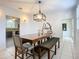 Bright dining room with wooden table, view of kitchen and entryway at 226 Mitnik Dr, Deltona, FL 32738