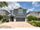 Two-story house with gray siding and a double-car garage at 420 Lasso Dr, Kissimmee, FL 34747