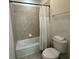 Bathroom features a bathtub, toilet, and shower at 420 Lasso Dr, Kissimmee, FL 34747