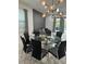 Dining area with a round glass table and black chairs at 420 Lasso Dr, Kissimmee, FL 34747
