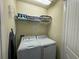 Convenient laundry room with washer, dryer, and shelving at 420 Lasso Dr, Kissimmee, FL 34747