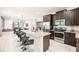 Modern kitchen with granite island, stainless steel appliances, and dark cabinets at 420 Lasso Dr, Kissimmee, FL 34747