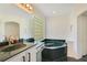 Elegant bathroom with a large soaking tub, double vanity, and a glass block window at 1434 Hidden Meadow Way, Apopka, FL 32712