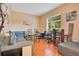 Comfortable living room with hardwood floors, a sectional sofa, and a workspace at 1434 Hidden Meadow Way, Apopka, FL 32712
