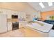 Bright kitchen with white cabinets, an island, and stainless steel appliances at 1434 Hidden Meadow Way, Apopka, FL 32712