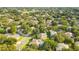 Aerial view of a residential neighborhood showcasing numerous houses, lush greenery, and a golf course at 1434 Hidden Meadow Way, Apopka, FL 32712