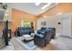 Spacious living room with vaulted ceiling, fireplace, and access to patio at 1434 Hidden Meadow Way, Apopka, FL 32712