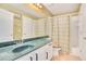 Bathroom with green vanity and shower/tub combo at 1434 Hidden Meadow Way, Apopka, FL 32712