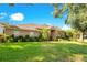Brick house with a lush lawn and mature trees at 1434 Hidden Meadow Way, Apopka, FL 32712