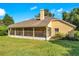 House back view, screened porch, and grassy backyard at 1434 Hidden Meadow Way, Apopka, FL 32712