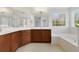 Elegant bathroom with a large corner tub, double vanity, and plenty of light at 8039 Northlake Pkwy, Orlando, FL 32827