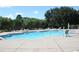 Community swimming pool with plenty of lounge chairs at 8039 Northlake Pkwy, Orlando, FL 32827