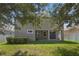 House exterior view with a patio and grassy backyard at 8039 Northlake Pkwy, Orlando, FL 32827