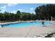 Community swimming pool with plenty of lounge chairs at 8039 Northlake Pkwy, Orlando, FL 32827