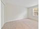 Bright bedroom with neutral walls, carpet, and a large window at 8039 Northlake Pkwy, Orlando, FL 32827