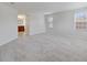 Large main bedroom with plush carpeting and an ensuite bathroom at 8039 Northlake Pkwy, Orlando, FL 32827