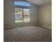 Living room with large window and neutral carpeting at 8130 Golden Chickasaw Cir, Orlando, FL 32825