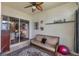 Spacious enclosed patio offers a striped couch, a ceiling fan and access to the interior at 2366 Prairie Dunes, Clermont, FL 34711